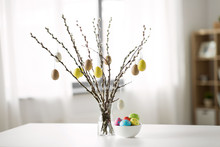 Holidays And Object Concept - Pussy Willow Branches Decorated By Easter Eggs In Vase On Table