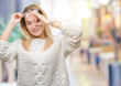 © Krakenimages.com - Young caucasian woman wearing glasses over isolated background doing ok gesture with hand smiling, eye looking through fingers with happy face.
