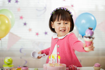 toddler girl celebrating her third birthday at home