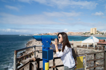 Wall Mural - Pretty long hair brunette girl relaxing near ocean.