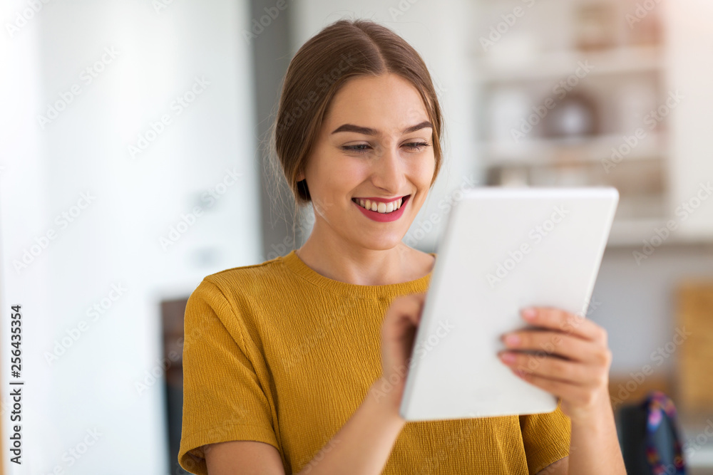 Young woman using digital tablet at home - obrazy, fototapety, plakaty 
