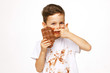 little boy with face and hands in chocolate 