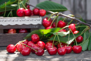 Wall Mural - Cherries with leaves in vintage wooden box on rustic wooden table. Copy space