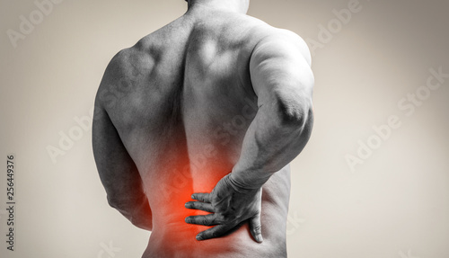 Muscle man with pain in his back Fototapet