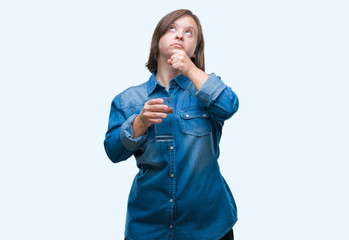 Sticker - Young adult woman with down syndrome drinking water over isolated background serious face thinking about question, very confused idea