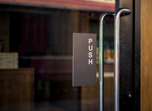 Restaurant Door Handle With Push Sign On Glass Doors