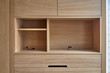 Wooden cupboard with drawers and empty shelves. Modern furniture