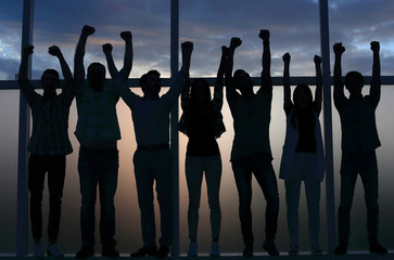 Wall Mural - business team standing near the window with hands up