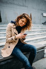 Wall Mural - Happy female holding mobile device