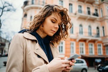 Wall Mural - Portrait of young woman wearing beige coat and hoodie