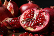 Delicious ripe pomegranates on table, closeup view
