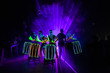 © Artem Orlyanskiy - laser show performance, dancers in suits with LED lamp