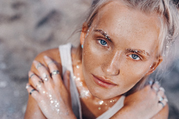 beautiful young fashion model on the beach. Close up portrait of boho model with sparkling boho accessories