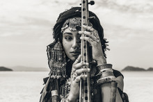 Beautiful Young Stylish Tribal Woman In Oriental Costume Playing Sitar Outdoors. Close Up