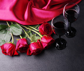 Wall Mural - Two glasses of red wine, drapery and a bouquet of red roses