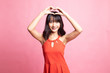 © halfbottle - Young Asian woman gesturing  heart hand sign.