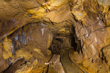 Undeground gold mine tunnel drift with rails