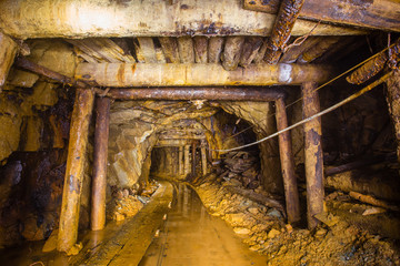 Undeground gold mine tunnel drift with rails