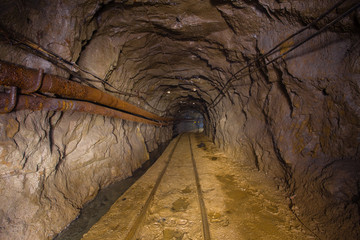 Underground gold mine tunnel drift with rails