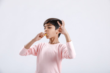 Canvas Print - Cute indian/Asian little boy eating Mango with multiple expressions. isolated over white background