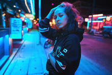 Neon Close Up Portrait Of Young Woman Wear Hoodie. Night City Street Shot