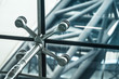 © tarapatta - Architecture abstract background. Glass curtain walls. Metal fasteners elements of spider glass system. Facade detail Windows