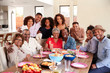 © Monkey Business - Senior black couples sitting at dinner table celebrating at home with family,selective focus