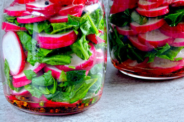 Wall Mural - Radish salad with spinach in a jar. Fitness salad in the jar. Fresh radishes and fresh chopped spinach leaves. Vegetable salad in a jar to go.