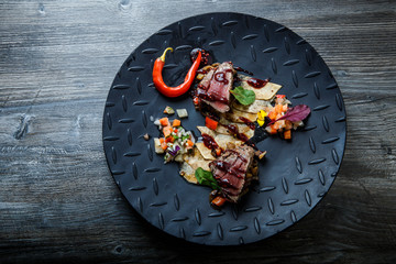 top view two pieces of medium raw grilled meat with red pepper