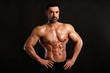 © Bas - Portrait of young handsome  muscular bodybuilder on black background