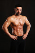 © Bas - Portrait of young handsome  muscular bodybuilder on black background