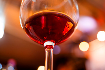 Wall Mural - Glass of red wine detail with blurry background closeup