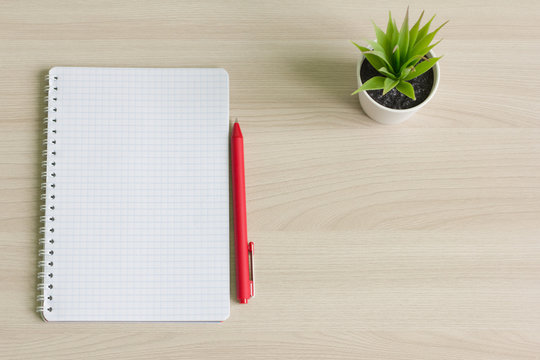 open writing pad and ballpoint pen on Desk