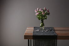 Vase With Beautiful Roses On Table Against Grey Background
