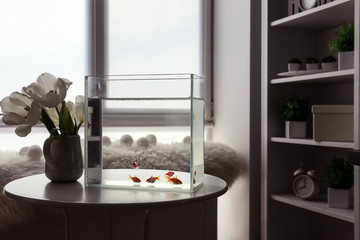 Poster - Beautiful aquarium and vase with flowers on table in room