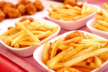 Canvas Print - French fries and fried nuggets in market