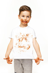 little boy with face and hands in chocolate 