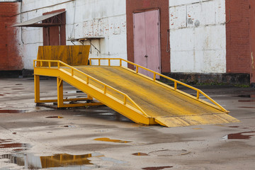 Metal ramp for unloading of cars in a warehouse.