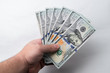© PH German Alvarez - Man's hand holding many hundred dollar bills. Business concept. Finance concept.