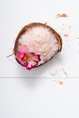 Wall Mural - pile of pink bath salt with orchid flower at coconut shell bowl, white wood table