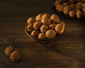 Walnuts in the Bowl lie on a wooden table