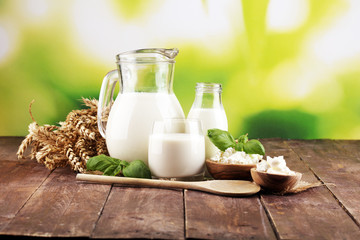 milk products. tasty healthy dairy products on a table. sour cream in a white bowl, cottage cheese bowl, cream in a a bank and milk jar, glass bottle and in a glass