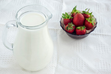 Wall Mural - White milk in jug and garden strawberry in vase for healthy breakfast