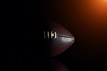 Wall Mural - American football ball isolated on black background