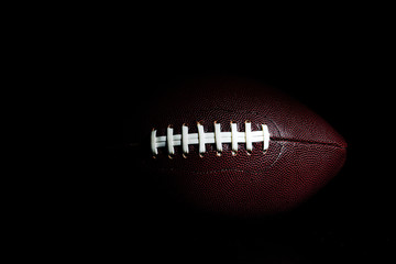 Wall Mural - American football ball isolated on black background