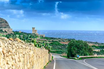 Wall Mural - Malta: Scenic road to Ghar Lapsi tower with hilly landscape and sea