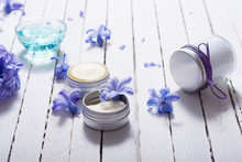 Skin Care Product Samples And Purple Hyacinth Flowers On White Wooden