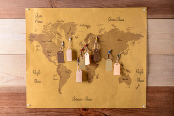 Sticker - World map with tags on wooden wall