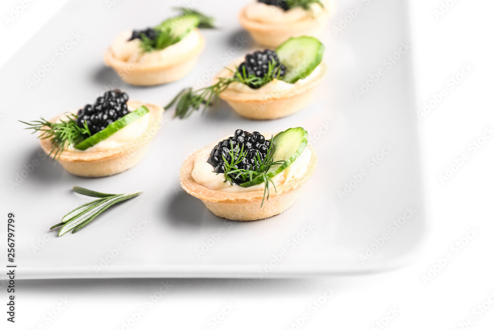 Plate with tasty canapes on white background, closeup
