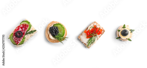 Fotomural Assortment of tasty canapes on white background